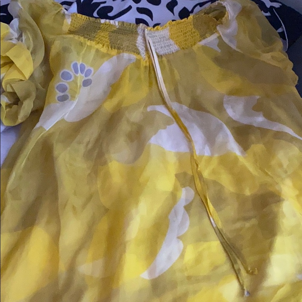A see through silky yellow shirt